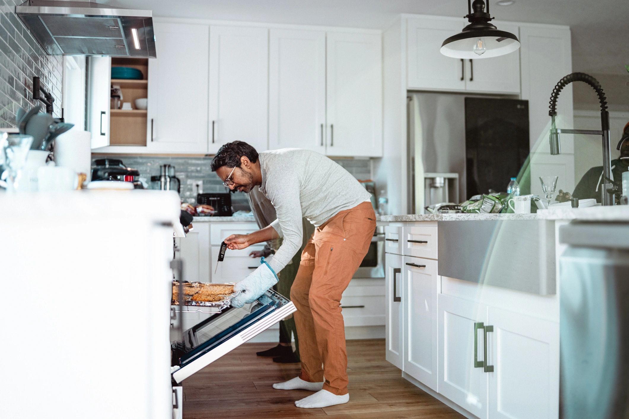 Technician checking an oven in a home kitchen